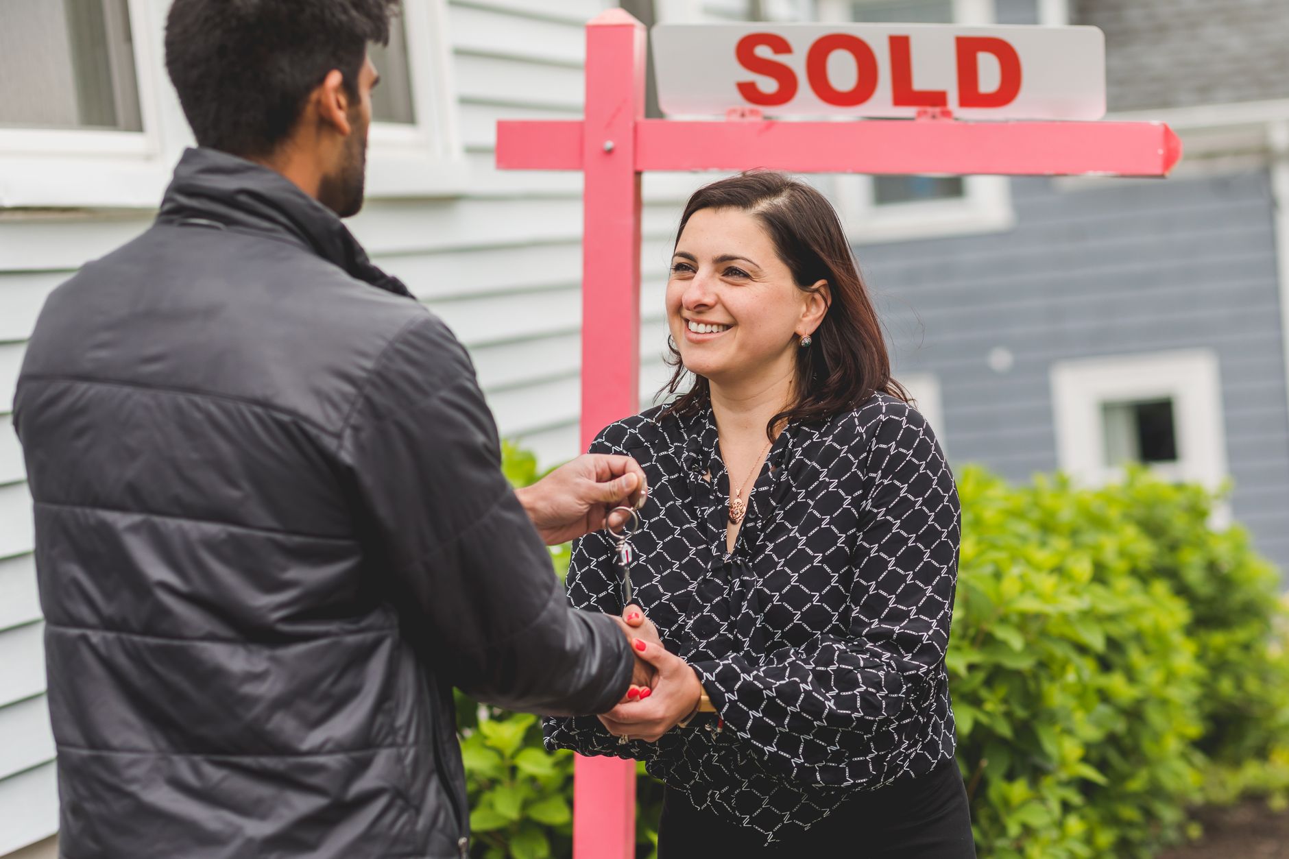 Real estate agent handing keys to a new homeowner